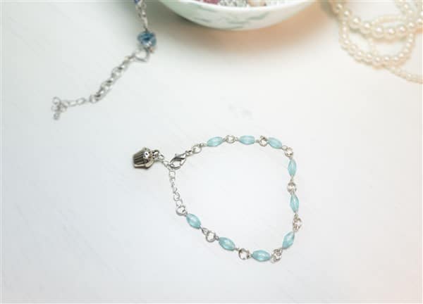 dezentes Armband mit Muffin Anhänger  aus gefrosteten blauen Perlen basteln