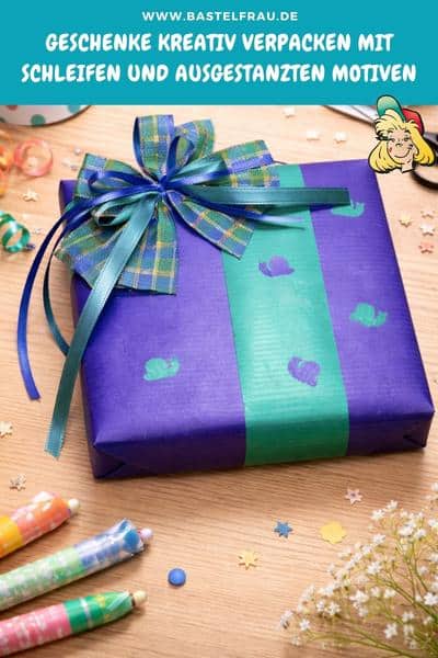 Geschenke kreativ verpacken mit Schleifen und ausgestanzten Motiven